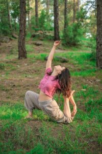 Woman Practicing Yoga in Forest